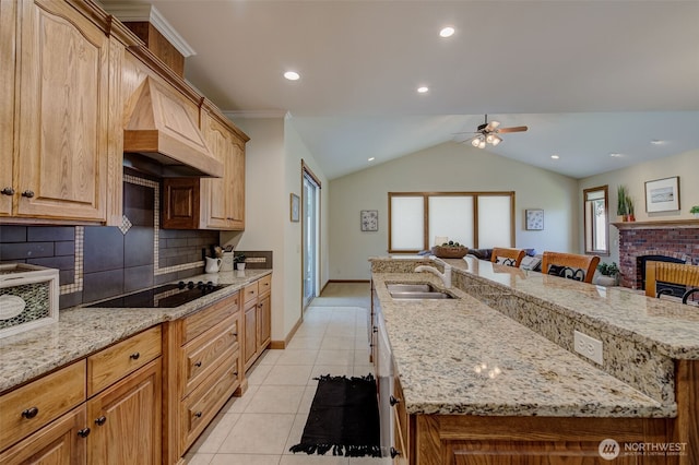 3716 Knowles Rd, Wenatchee, WA 98801 - kitchen featuring black electric cooktop, an island with sink, light tile patterned floors, backsplash, and a ceiling fan