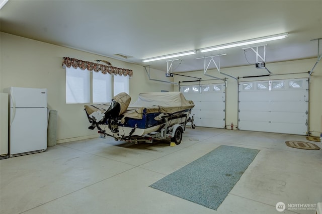 3716 Knowles Rd, Wenatchee, WA 98801 - garage featuring freestanding refrigerator and a garage door opener