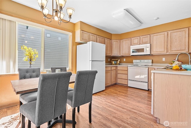 639 W Horton Way Unit 228, Bellingham, WA 98226 - kitchen featuring white appliances, light brown cabinetry, a chandelier, and light countertops
