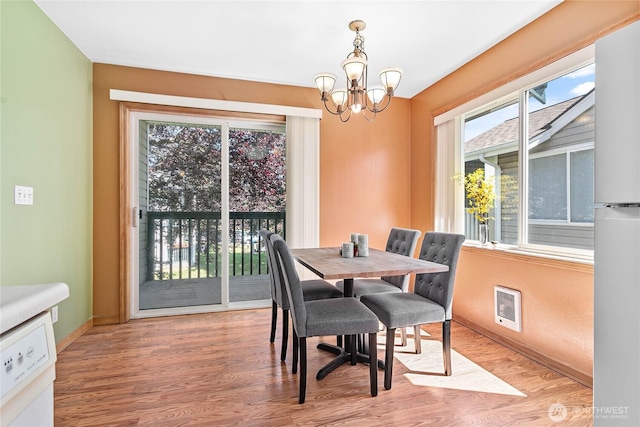 639 W Horton Way Unit 228, Bellingham, WA 98226 - dining area featuring plenty of natural light, a chandelier, light wood-style flooring, and heating unit