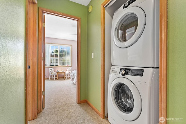 639 W Horton Way Unit 228, Bellingham, WA 98226 - laundry area featuring stacked washer / dryer and light carpet