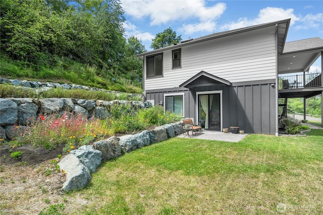 13830 Old Snohomish Monroe Rd, Snohomish, WA 98290 - rear view of house with board and batten siding, a patio area, and a lawn
