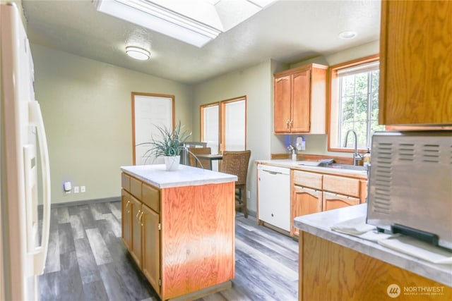 4508 36th Ct SE, Lacey, WA 98503 - kitchen featuring white appliances, a kitchen island, a skylight, and light countertops