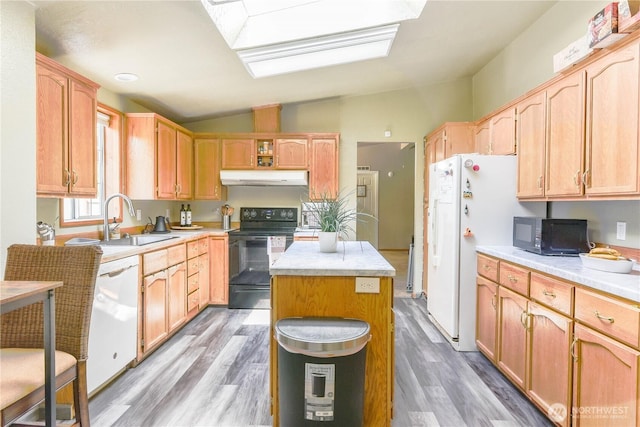 4508 36th Ct SE, Lacey, WA 98503 - kitchen featuring black appliances, under cabinet range hood, vaulted ceiling, light countertops, and light wood-style flooring