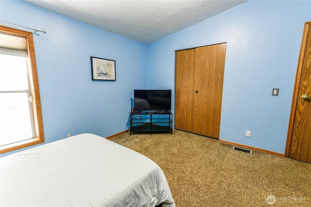4508 36th Ct SE, Lacey, WA 98503 - bedroom with multiple windows, carpet flooring, and a textured ceiling
