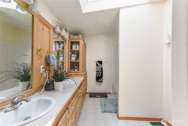 4508 36th Ct SE, Lacey, WA 98503 - bathroom with tile patterned floors, double vanity, and a skylight