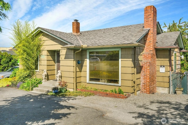 9713 4th Ave W, Everett, WA 98204 - view of front of house featuring a chimney and a shingled roof
