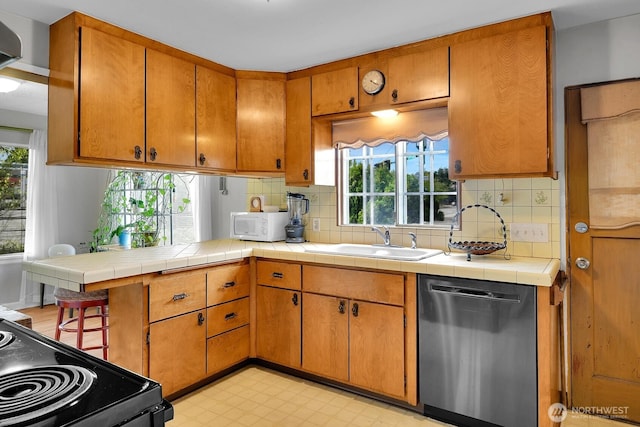 9713 4th Ave W, Everett, WA 98204 - kitchen featuring stainless steel dishwasher, black range with electric stovetop, decorative backsplash, and healthy amount of natural light