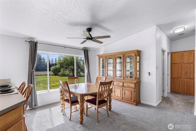 8654 Valley View Rd, Custer, WA 98240 - dining room with ceiling fan, a textured ceiling, light colored carpet, and vaulted ceiling