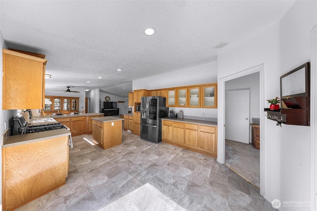 8654 Valley View Rd, Custer, WA 98240 - kitchen featuring black fridge with ice dispenser, a textured ceiling, glass insert cabinets, stainless steel microwave, and recessed lighting