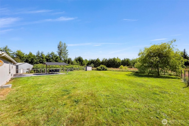 8654 Valley View Rd, Custer, WA 98240 - fenced backyard featuring a storage unit, a patio, and a carport
