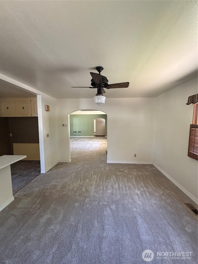 214 N 2nd St, Dayton, WA 99328 - carpeted empty room featuring ceiling fan, arched walkways, and a textured ceiling