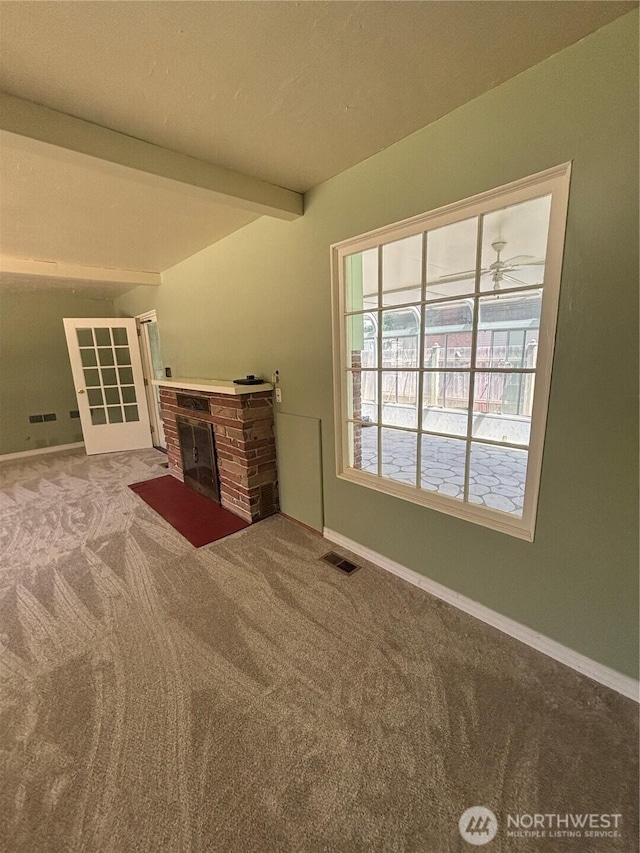 214 N 2nd St, Dayton, WA 99328 - unfurnished living room with carpet flooring, a fireplace with flush hearth, and beam ceiling