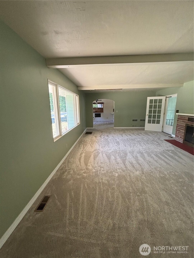 214 N 2nd St, Dayton, WA 99328 - unfurnished living room featuring carpet floors, arched walkways, and a fireplace