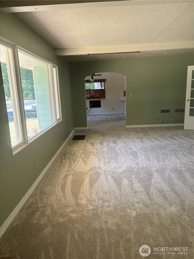 214 N 2nd St, Dayton, WA 99328 - empty room with arched walkways, carpet, and a wall mounted air conditioner
