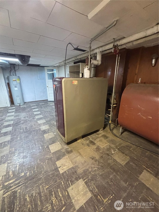 214 N 2nd St, Dayton, WA 99328 - unfinished below grade area with oil tank, water heater, and tile patterned floors