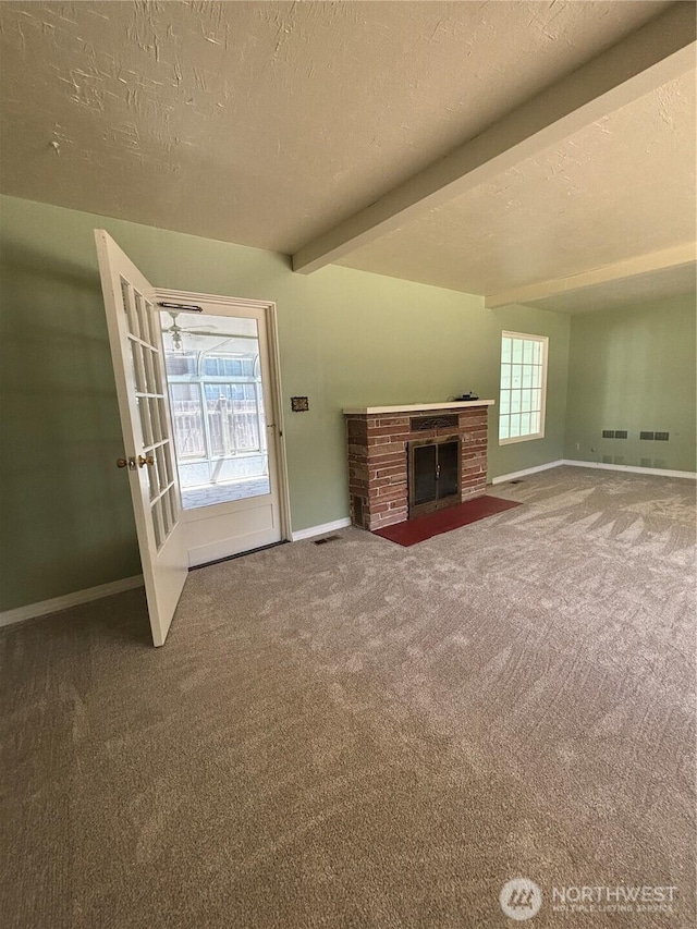 214 N 2nd St, Dayton, WA 99328 - unfurnished living room featuring carpet flooring, beamed ceiling, a fireplace, and a textured ceiling