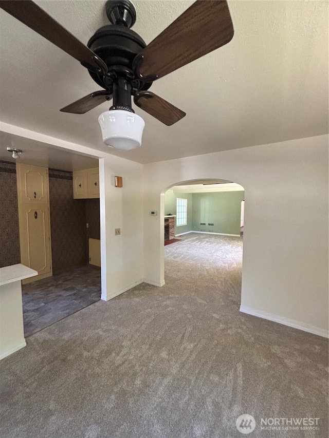 214 N 2nd St, Dayton, WA 99328 - empty room featuring arched walkways, carpet floors, and a ceiling fan