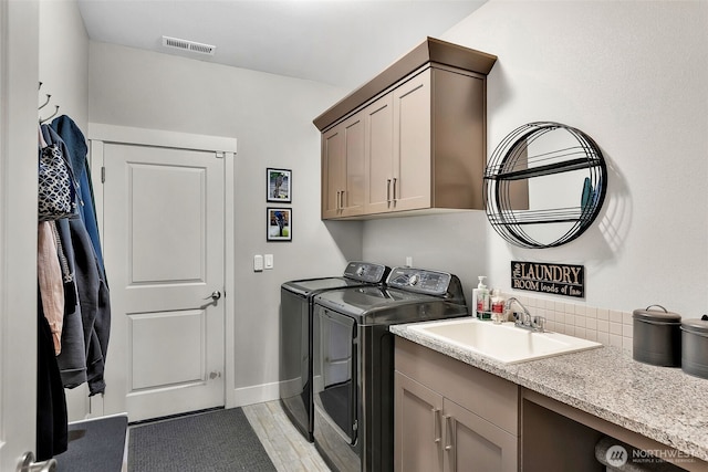 9511 W Floyd Dr, Cheney, WA 99004 - laundry area featuring washer and dryer, cabinet space, and light wood-type flooring