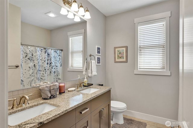 9511 W Floyd Dr, Cheney, WA 99004 - full bath with double vanity, decorative backsplash, wood finished floors, and a shower with shower curtain