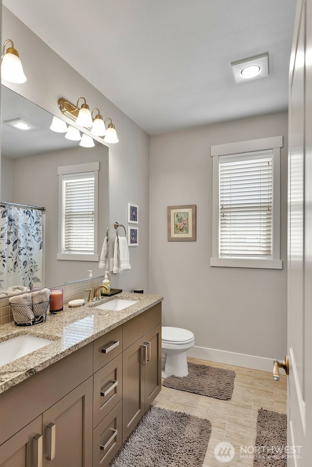 9511 W Floyd Dr, Cheney, WA 99004 - bathroom with double vanity and a shower with shower curtain