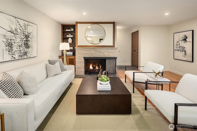 5244 Pullman Ave NE, Seattle, WA 98105 - living area with a stone fireplace, light wood-style flooring, and recessed lighting
