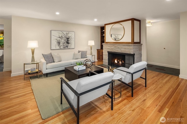 5244 Pullman Ave NE, Seattle, WA 98105 - living room with a stone fireplace, light wood-style flooring, and recessed lighting