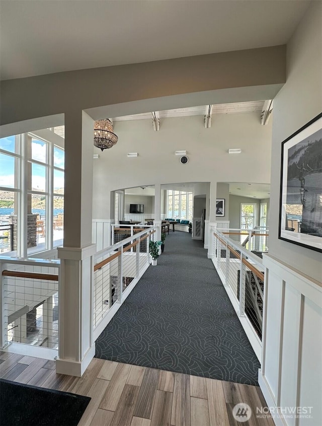 1350 W Woodin Ave Unit Ede2, Chelan, WA 98816 - hallway with wood finished floors, beam ceiling, a chandelier, and an upstairs landing