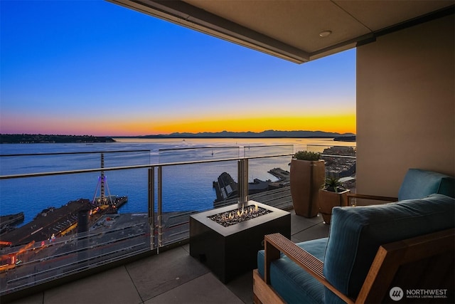 99 Union St Unit 1601, Seattle, WA 98101 - balcony at dusk with an outdoor fire pit and a water view