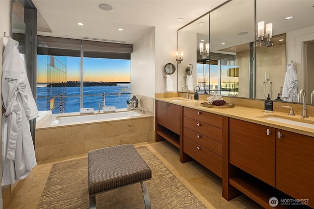 99 Union St Unit 1601, Seattle, WA 98101 - full bath featuring a bath, double vanity, a water view, and recessed lighting