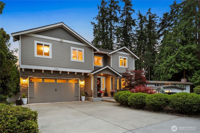 230 155th Pl SE, Bothell, WA 98012 - view of front facade featuring a garage, stone siding, driveway, and board and batten siding