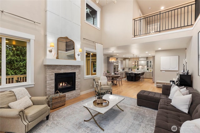 230 155th Pl SE, Bothell, WA 98012 - living room with light wood finished floors, a fireplace, and a towering ceiling