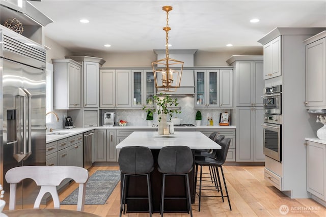 230 155th Pl SE, Bothell, WA 98012 - kitchen featuring gray cabinetry, stainless steel appliances, light wood-style flooring, light countertops, and recessed lighting