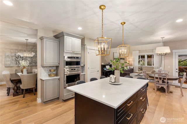 230 155th Pl SE, Bothell, WA 98012 - kitchen featuring a chandelier, light countertops, recessed lighting, double oven, and light wood-style floors