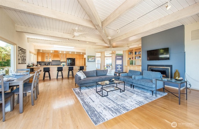 2641 E Bay St, Port Angeles, WA 98362 - living area with light wood finished floors, a fireplace, and a wooden ceiling with exposed beams