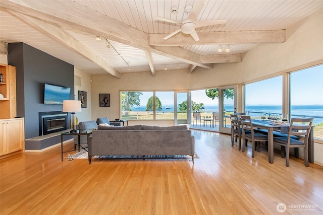 2641 E Bay St, Port Angeles, WA 98362 - living room with a wood ceiling with exposed beams, light wood-style floors, a water view, a ceiling fan, and a glass covered fireplace