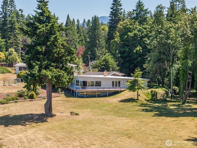 2641 E Bay St, Port Angeles, WA 98362 - rear view of house featuring a lawn, a wooded view, and a wooden deck