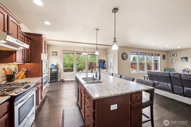 17116 138th Ave E, Puyallup, WA 98374 - kitchen with appliances with stainless steel finishes, a kitchen breakfast bar, recessed lighting, plenty of natural light, and under cabinet range hood