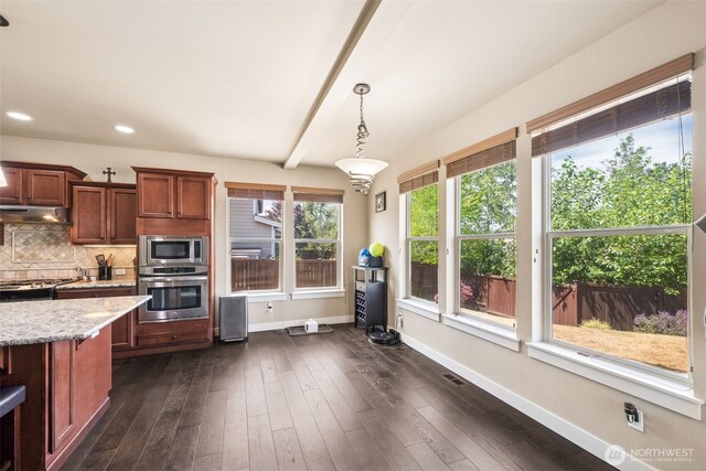 17116 138th Ave E, Puyallup, WA 98374 - kitchen featuring appliances with stainless steel finishes, light stone countertops, tasteful backsplash, dark wood-style floors, and pendant lighting