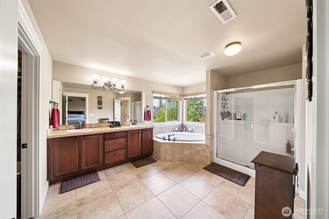 17116 138th Ave E, Puyallup, WA 98374 - full bath with a garden tub, tile patterned floors, a shower stall, double vanity, and a chandelier