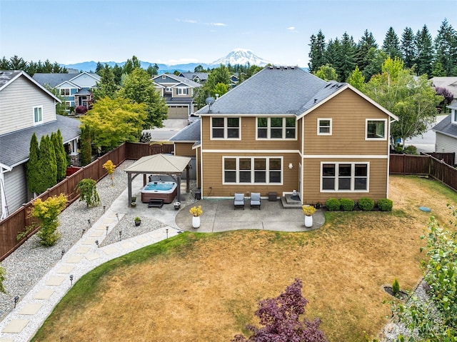 17116 138th Ave E, Puyallup, WA 98374 - back of property featuring a gazebo, an outdoor hangout area, a patio, a fenced backyard, and a mountain view