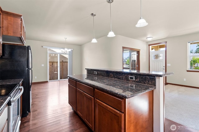 2309 43rd Ave SE, Puyallup, WA 98374 - kitchen with stainless steel electric stove, a chandelier, a center island, wood finished floors, and decorative light fixtures