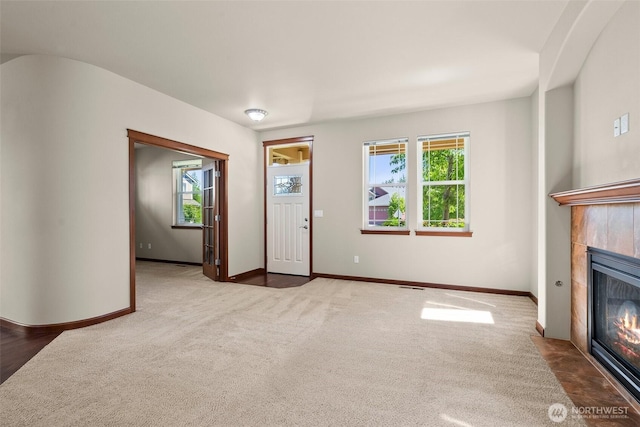 2309 43rd Ave SE, Puyallup, WA 98374 - unfurnished living room featuring carpet, a fireplace, and healthy amount of natural light