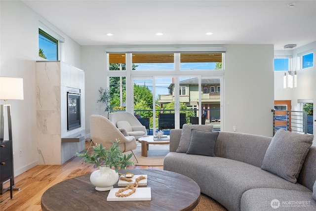 6012 Palatine Ave N, Seattle, WA 98103 - living area with light wood finished floors, a tile fireplace, plenty of natural light, and recessed lighting