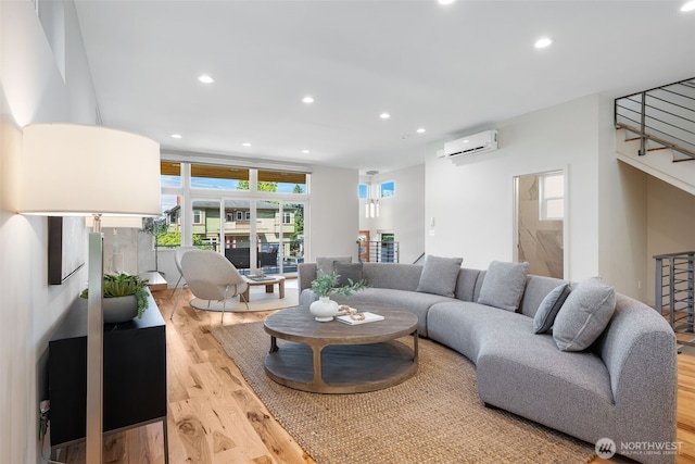 6012 Palatine Ave N, Seattle, WA 98103 - living room featuring a wall mounted air conditioner, light wood-type flooring, stairs, and recessed lighting