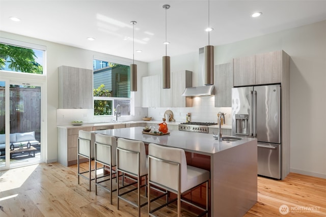6012 Palatine Ave N, Seattle, WA 98103 - kitchen featuring modern cabinets, high quality fridge, wall chimney range hood, a kitchen breakfast bar, and recessed lighting