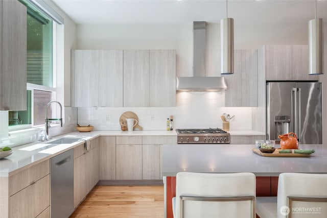 6012 Palatine Ave N, Seattle, WA 98103 - kitchen with appliances with stainless steel finishes, wall chimney exhaust hood, modern cabinets, and light brown cabinets