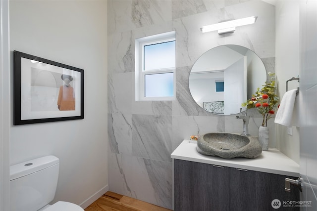 6012 Palatine Ave N, Seattle, WA 98103 - bathroom featuring vanity, decorative backsplash, and wood finished floors