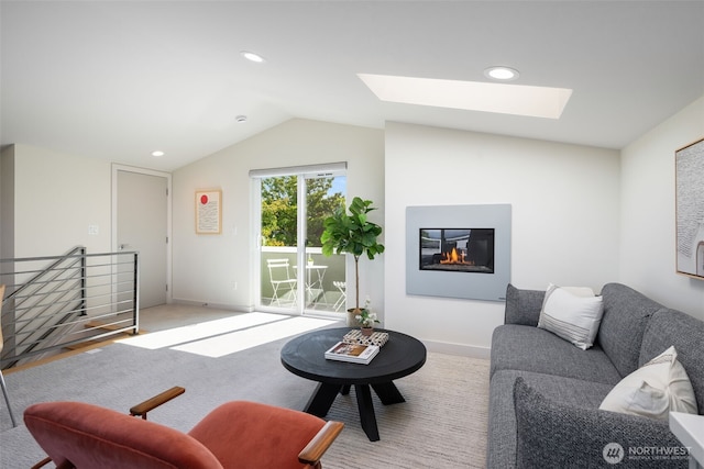 6012 Palatine Ave N, Seattle, WA 98103 - living room featuring a skylight, lofted ceiling, a glass covered fireplace, and recessed lighting