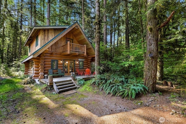 7010 Rainier Way, Deming, WA 98244 - log-style house featuring french doors, log exterior, and a view of trees